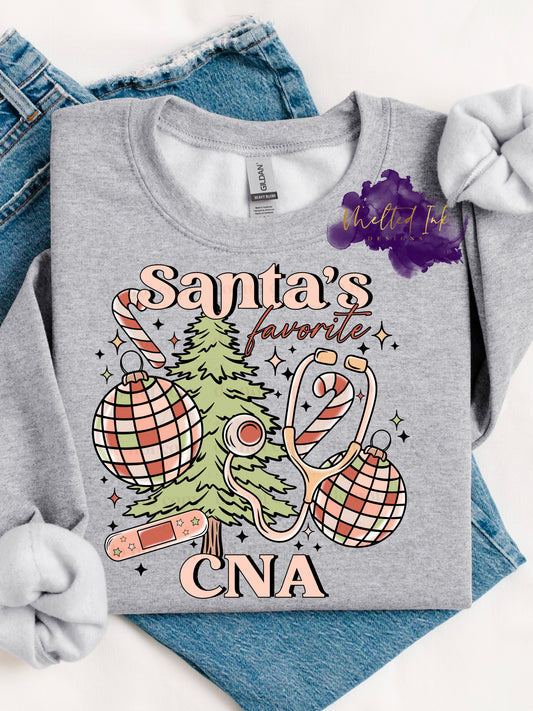 Photo is a mock up of design. Design is colored light pinks and light green and says Santa's Favorite CNA. Has picture of a christmas tree, ornaments, candy cane, stethascope and bandaid. 