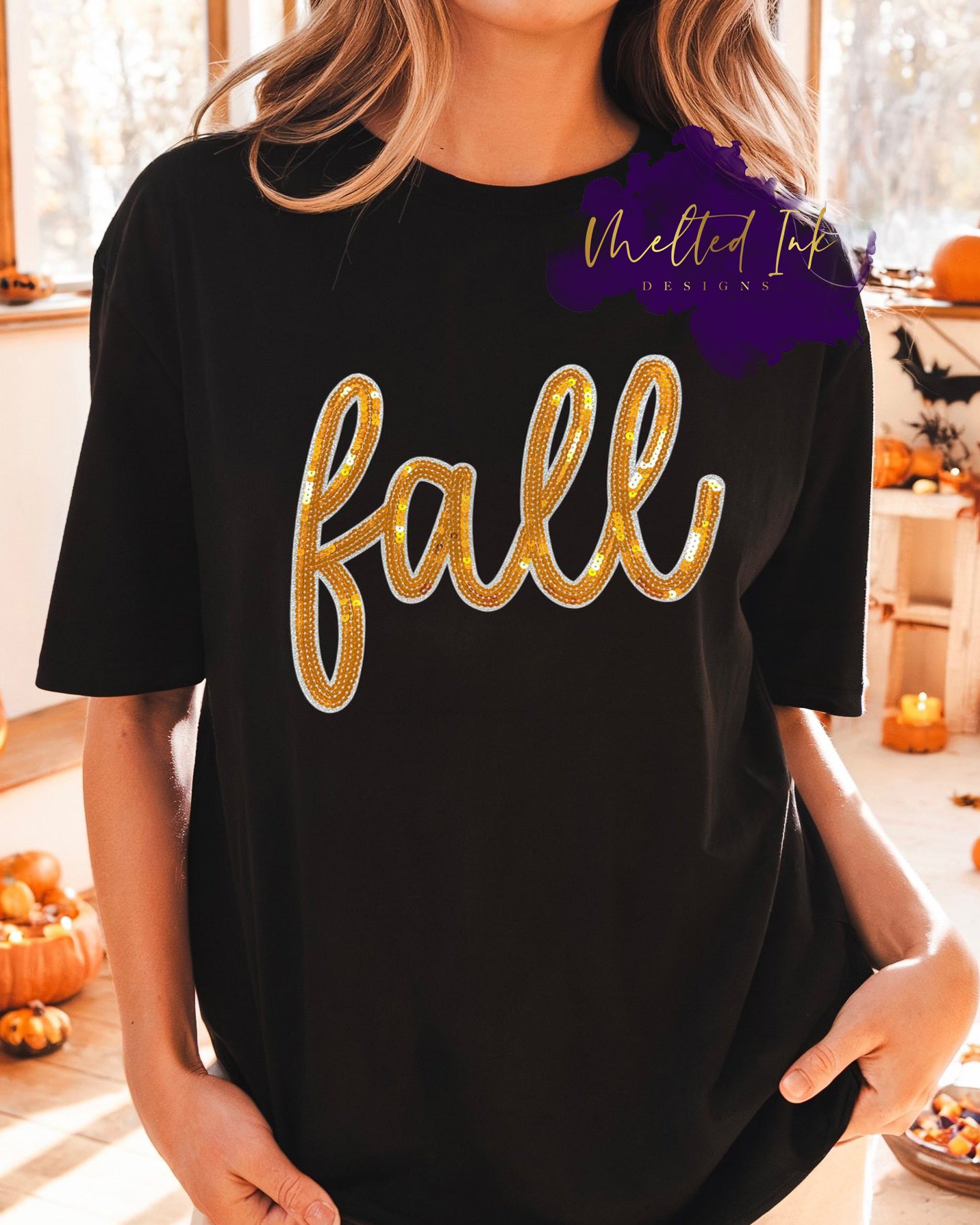 Shirt Design with the word “fall” in large, cursive lettering outlined with golden sequins. A sparkling autumn-inspired design perfect for seasonal shirts, sweatshirts, and hoodies