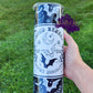 Photo consists of a 20oz halloween theme tumbler that says proud member of the spooky sorority. It has moon, bat and star elements throughout the design. 