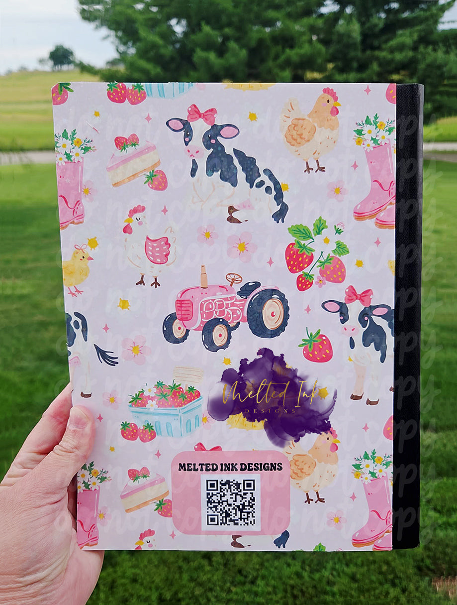 Farm-themed composition notebook featuring cows with bows, chickens, strawberries, flowers, pink rain boots, hay bales, and a vintage tractor on a light pink background with a customizable label area.