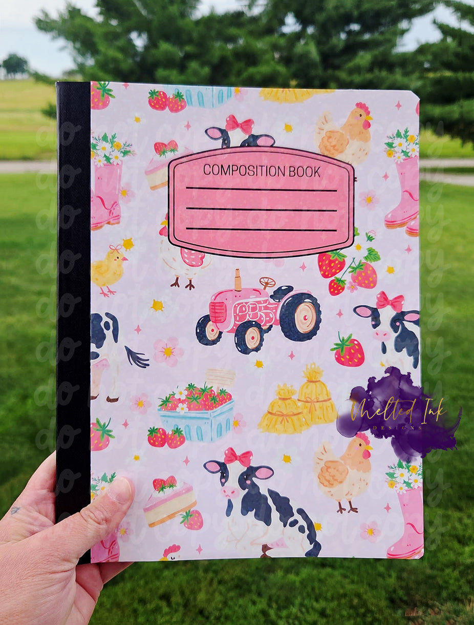 Farm-themed composition notebook featuring cows with bows, chickens, strawberries, flowers, pink rain boots, hay bales, and a vintage tractor on a light pink background with a customizable label area.