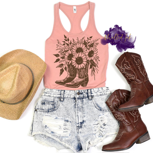 Sunflower and Cowgirl Boots Shirt – A cozy tee featuring a sunflower design paired with rustic cowgirl boots, blending floral and Western elements in a charming graphic.