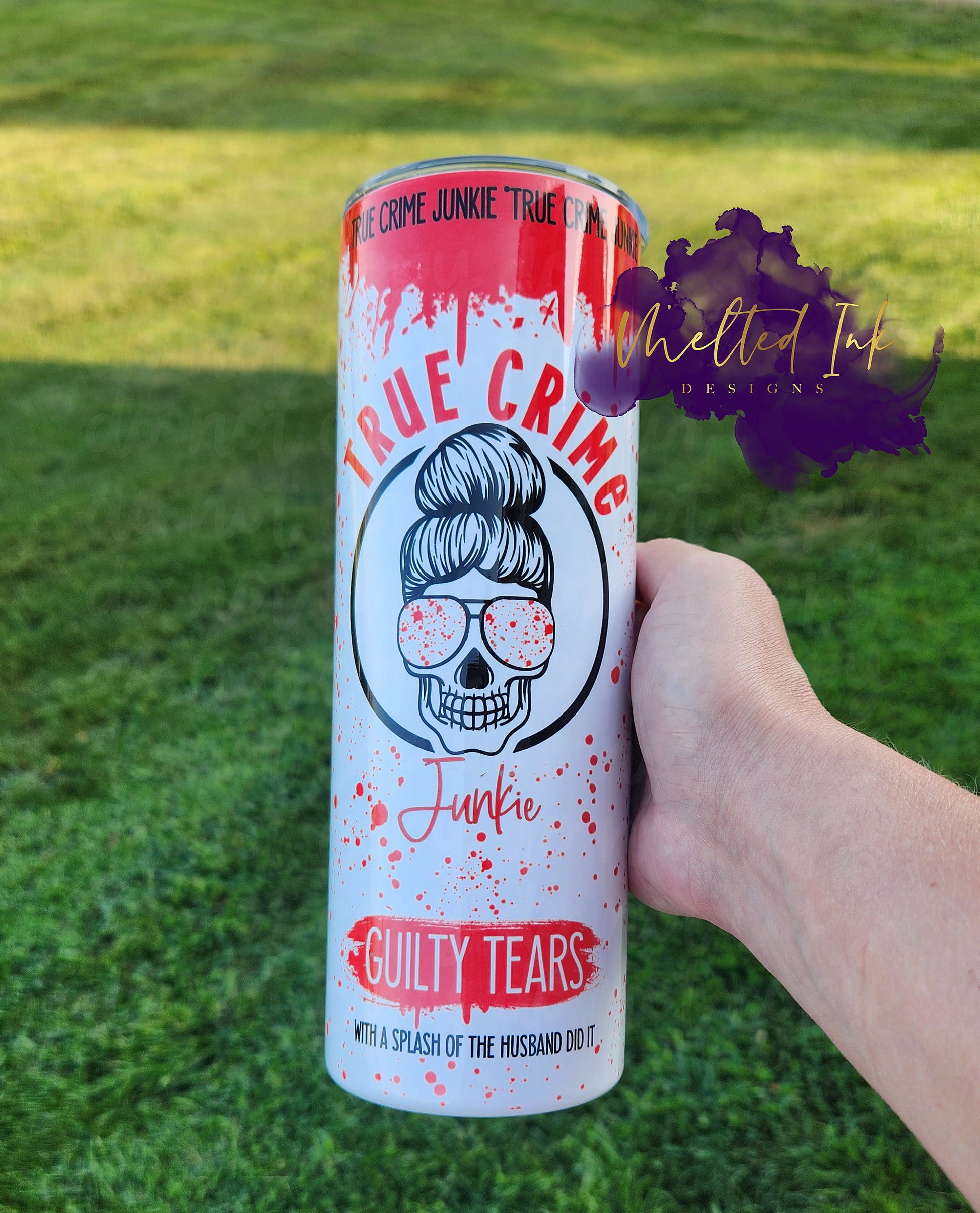 Photo consists of 20oz tumbler that says true crime junkie guilty tears with a splash of the husband did it. Has a skeleton head in the center with blood splatter sunglasses. Background has fake blood splatters. 