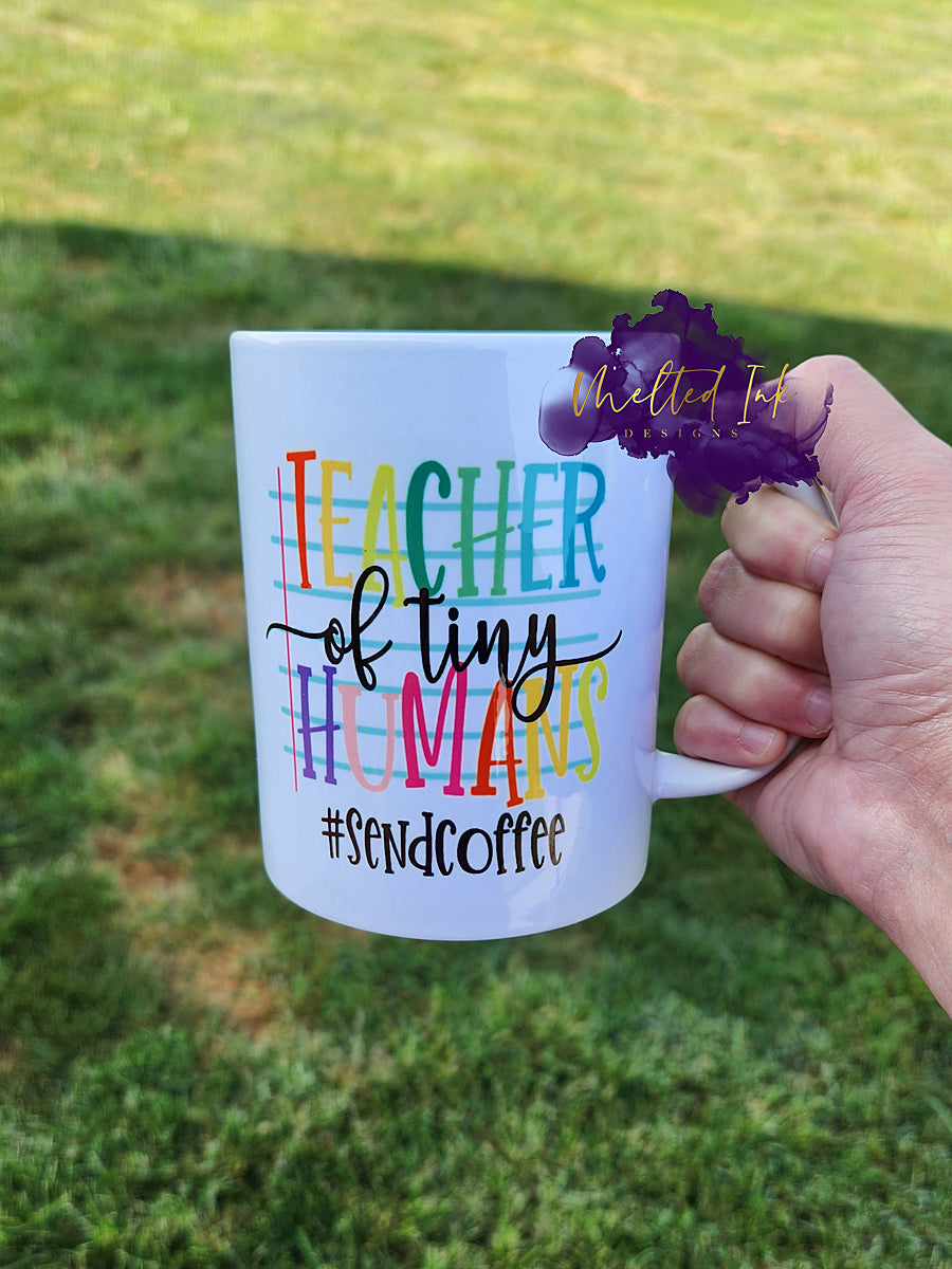 Photo is a 15oz mug that says Teacher of Tiny Humans #sendcoffee