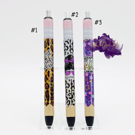 Photo consists of 3 different epoxy pens. #1 is made to look like a pencil and is leopard print that says best teacher ever. #2 is made to look like a pencil and has a composition print that says #teacherlife and #3 is also made to look like a pencil with a purple background with different colored starts and says difference maker #teacher. All there have a glitter overlay and has black ink. 