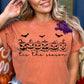 Photo is a mock up of the design. Print design is black and pressed on an orange shirt. Design consists of 6 smaller pumpkins in a row with 3 bats flying above them. Shirt says Tis the Season. 