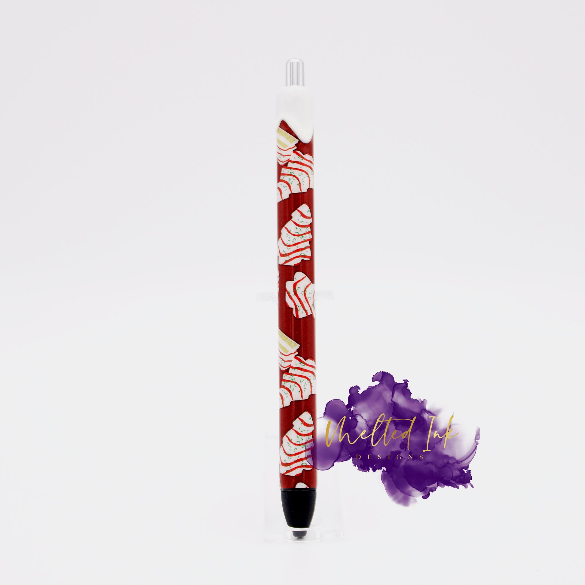 Photo shows an epoxy vinyl wrapped ink pen that has Christmas tree cakes design. Pen includes black ink. 