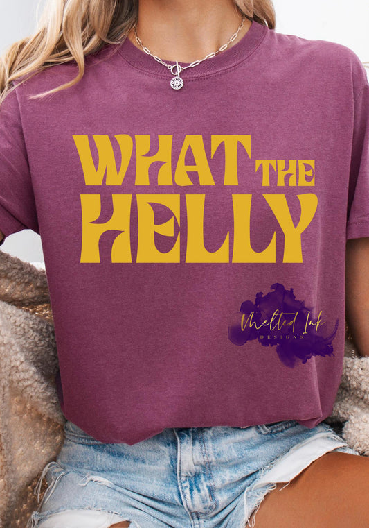 Large bold yellow retro lettering that reads “What The Helly.” The font has a playful, vintage ‘70s look with thick, curved letters.