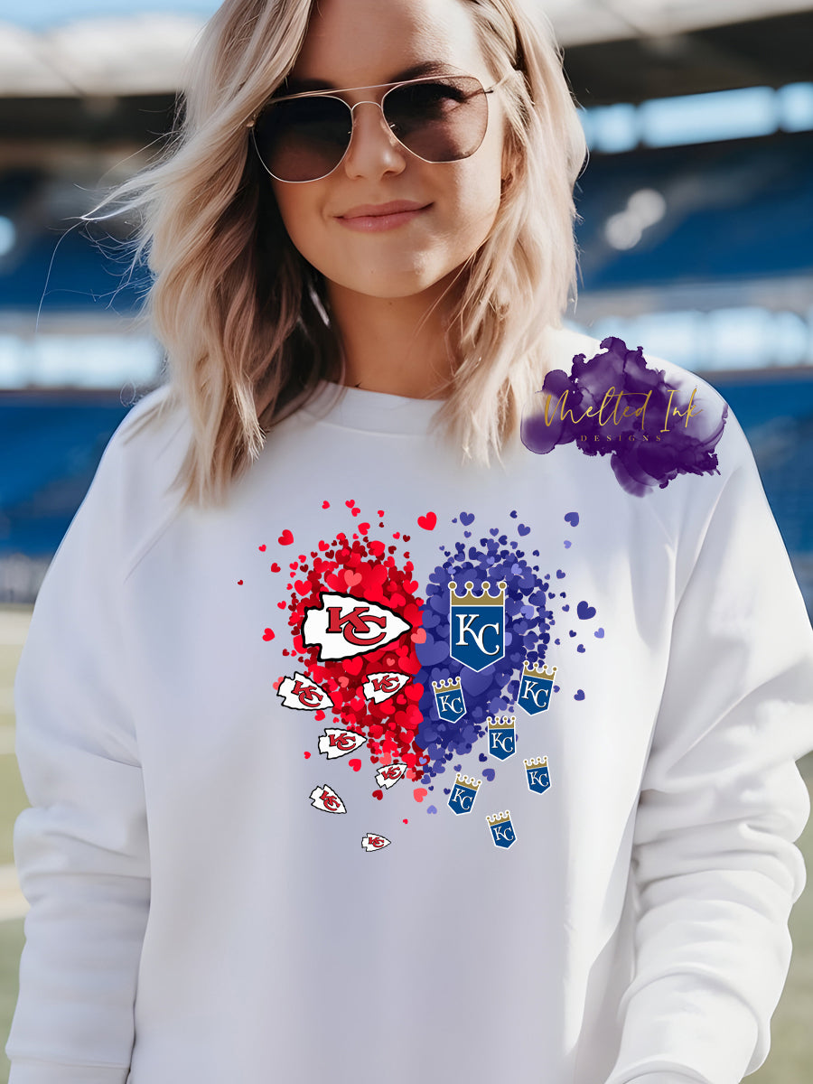 Design is a mock up and is of a heart that is red and blue confetti hearts that says KC Football and KC Baseball teams. 