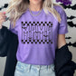 Photo is a mock up of the design. The design color is black and is pressed on a purple shirt. Design says MAMA and it includes stars and bats flying over the word MAMA. Checker print placed above and below MAMA. 