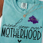 Photo is a mock up of the design and the design says mind your own motherhood. 