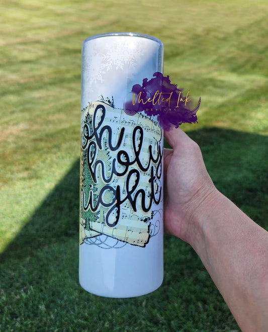 Photo is a 20oz tumbler that says oh holy night over top of a sheet of music